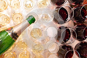 Closeup of the hand of the waiter pouring champagne into glasses