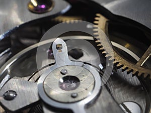 Closeup of hand watch mechanism gears under the lights