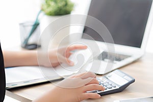 Closeup hand woman calculating expenses household and writing notebook on desk, girl checking bill and stress and note