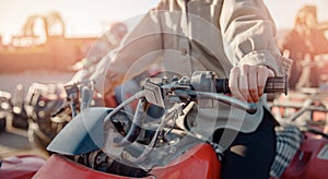 Closeup hand of woman on quad bike ATV safari in desert Sharm Hurghada, Egypt sunlight