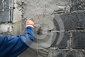 closeup hand of worker plastering cement at wall for building house