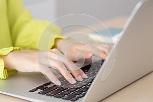 Closeup of hand young asian businesswoman working on laptop computer on desk at home office.