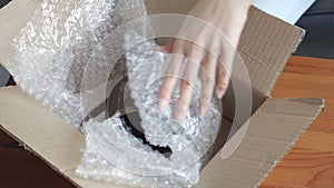 Closeup hand of young asian woman packing box at home, online shopping, logistic and delivery.