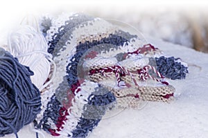 Closeup of handmade knitted baby booties in snow