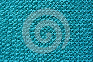 Closeup of handmade turquoise knitwork from above