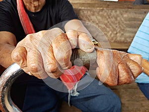 Closeup hands of asian old man holding cane suffering from lepr photo