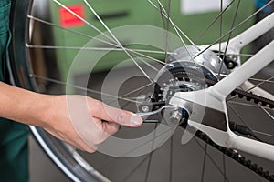 Closeup of the hands of bicycle mechanic at work