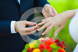 Closeup of hands of bridal unrecognizable couple with wedding rings. bride holds wedding bouquet of flowers.