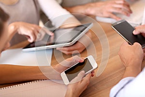 Closeup of hands of business people using tablets