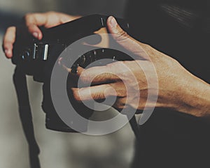 Closeup of hands checking film in camera