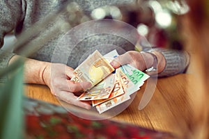 Closeup of hands count Euro banknotes