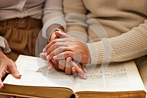 Closeup, hands and couple with bible, praying and support with love, spiritual and religious practice. Zoom, hand and