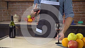 Closeup hands with goblet unrecognizable body in kitchen