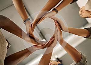 Closeup of hands of group of businesspeople in a circle. Diverse designers united in support. Fashion designer