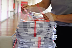 Closeup hands hold stack of used paper to recycle