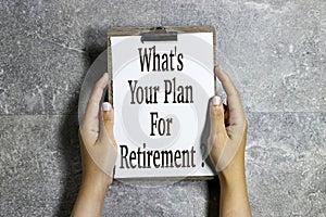 closeup hands holding a paper clipboard with What's Your Plan for Retirement ? concept