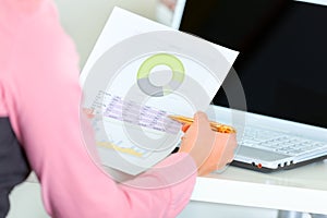 Closeup on hands holding pen and document