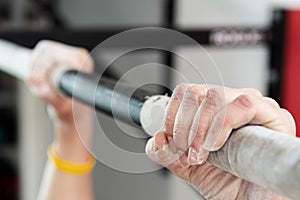 Closeup of hands holding a pull-ups bar