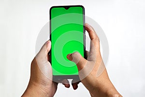 closeup of hands holding smart phones with green screen