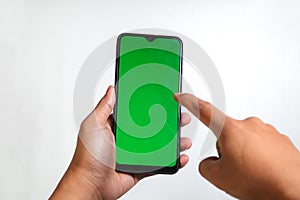 closeup of hands holding smart phones with green screen