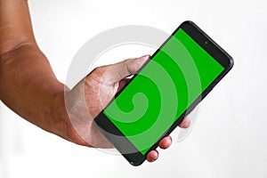 closeup of hands holding smart phones with green screen