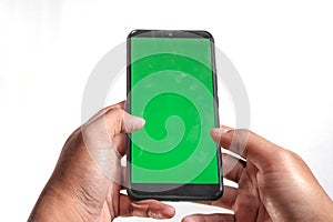 closeup of hands holding smart phones with green screen