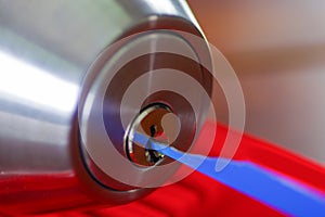 Closeup hands of locksmith using metal pick tools to open locked door