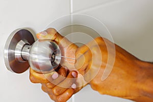 Closeup hands of locksmith using pick tools to open locked door