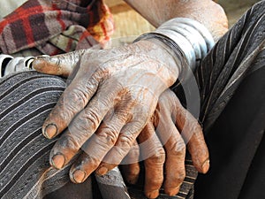 Closeup of the hands of a longneck woman in Myanmar
