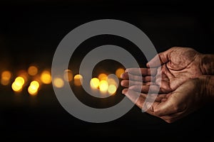 closeup hands of man begging for help. concept for poverty or hunger, seeking for light in the dark.