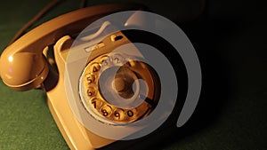 Closeup hands of man carefully places receiver of a vintage telephone in cradle