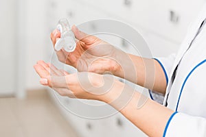 Closeup hands of a medical worker or pharmacist using disinfectant, hand sanitizer in hospital