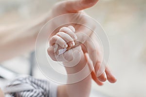 Closeup of the hands of the mother and the baby