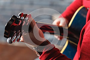 Closeup of hands of a musician playing acoustic guitar