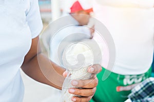 Closeup of the hands of a Nicaraguan woman holding a traditional dish called quesillo photo