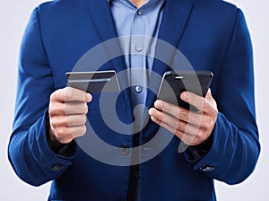 Closeup, hands and a person with a phone and credit card on a studio background for ecommerce. Website, digital or an