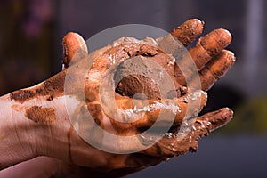 Closeup of hands of a potter with clay