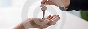 Closeup hands real estate agent giving keys to home owner