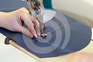 Closeup of hands of seamstresses processing cotton fabric with r