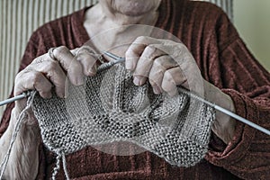 Closeup hands of a senior woman knitting