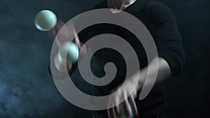 Closeup of hands in suit juggling white balls. Success and management