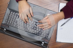 Closeup on Hands Typing on Keyboard, Notebook and Pen