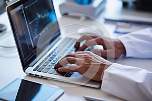 closeup of hands typing stem cell research findings on a laptop