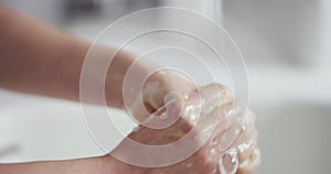 Closeup, hands and woman cleaning, bathroom and soap with sink, hygiene and self care. Zoom, female person and girl with