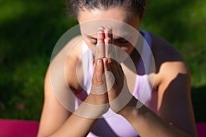 Closeup of hands of woman doing Yoga meditation exercises outdoor