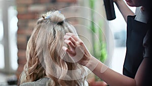 Closeup hands of woman hairdresser fixing curly hairstyle use hair spray. Shot with RED camera in 4K