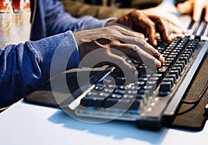 Closeup of hands working on computer keyboard