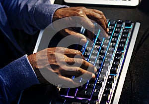 Closeup of hands working on computer keyboard