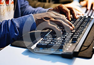 Closeup of hands working on computer keyboard photo