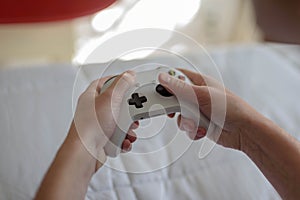 Close up of young man holding video game controller while playing video games